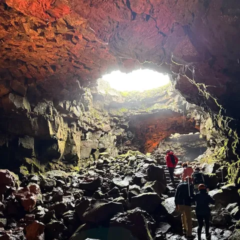 Walkers inside the Raufarholshellir lava tunnel