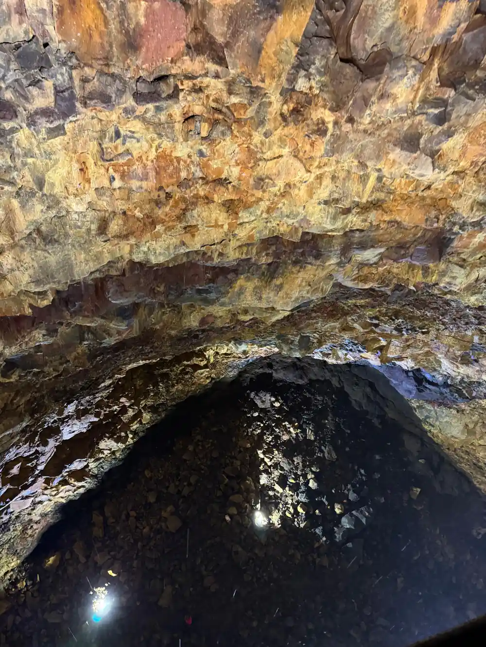 A boulder on the chamber floor with the gold wall rising behind it