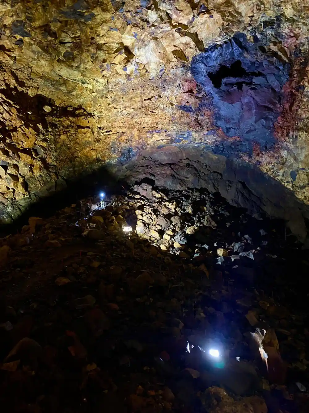 The dark upper chamber with lamps picking out the walls