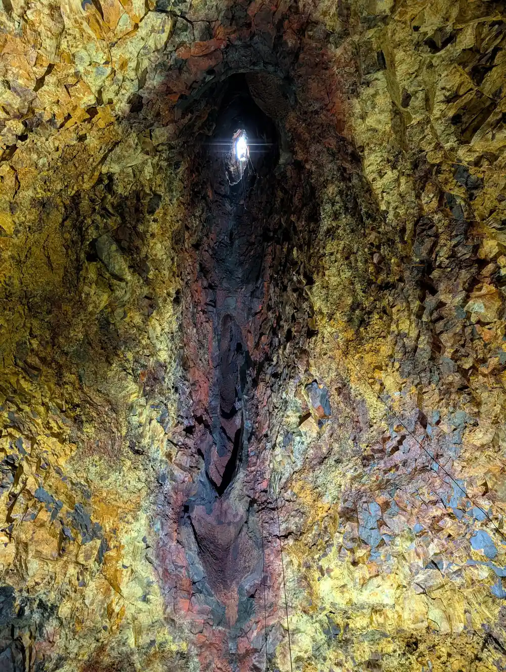 The full height of the chamber with the entrance shaft a bright point above