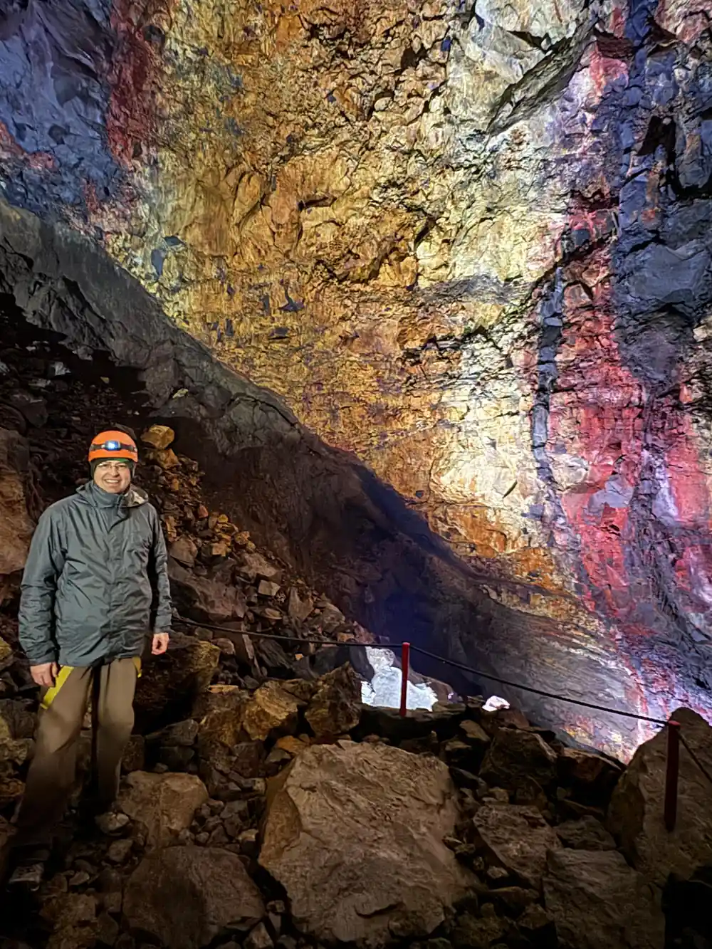 A visitor in a helmet beside the chamber wall