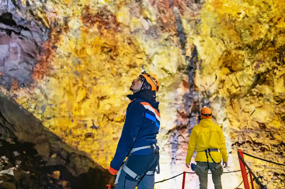 A visitor looking up at the yellow chamber wall