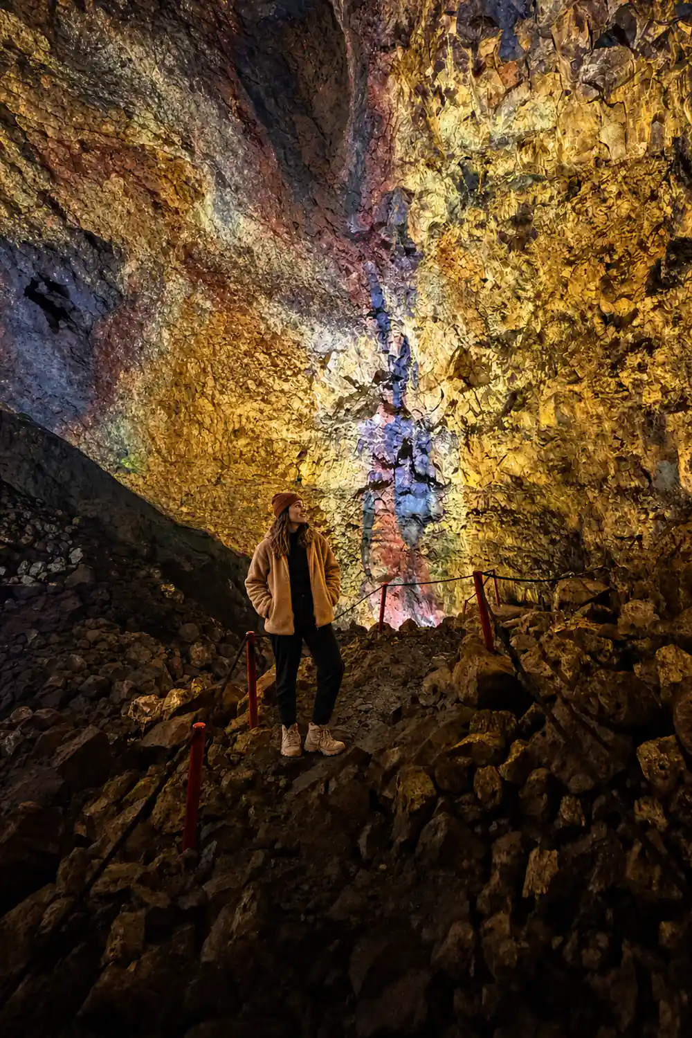 A visitor standing on the chamber floor against the streaked wall