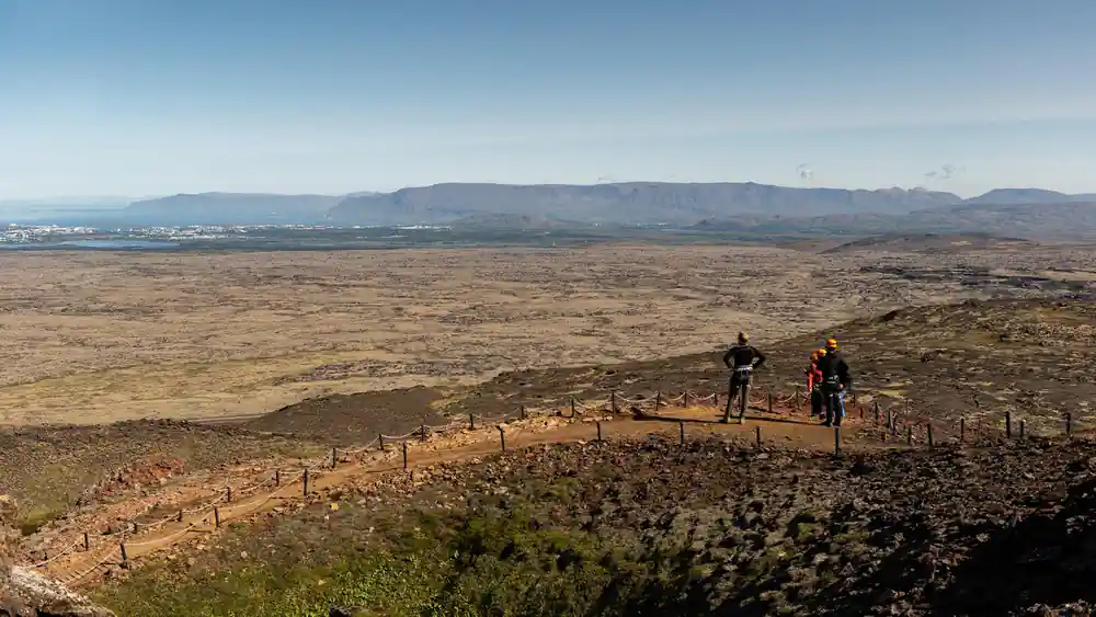 The wide lava plain from the rim with a flat-topped mountain beyond